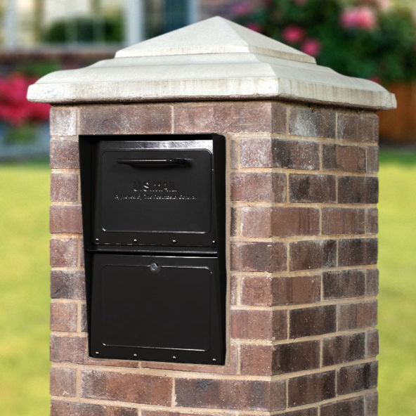 Black locking mailbox installed in brick